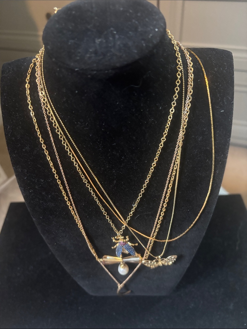 5 goldtone delicate necklaces.